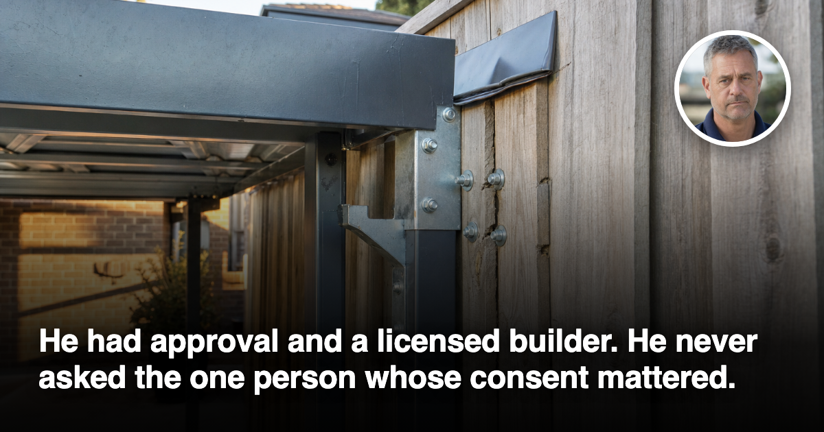 A galvanised steel carport bracket bolted through the timber palings of a boundary fence, with stress marks in the wood around the fixings