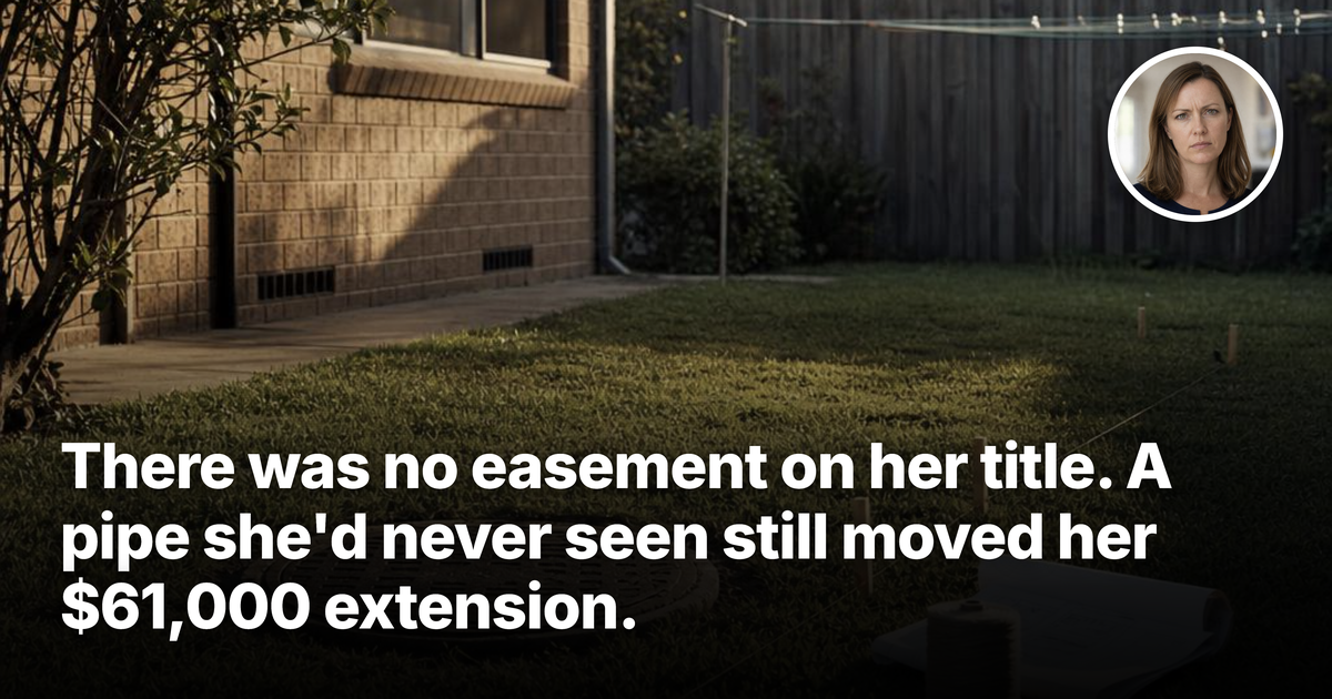 A round sewer maintenance access cover set into the lawn of a suburban backyard, with builder’s string lines and rolled architectural plans beside it