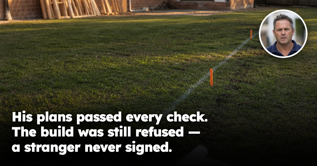 Marked services easement strip across a suburban backyard beside rolled building plans awaiting a rear extension