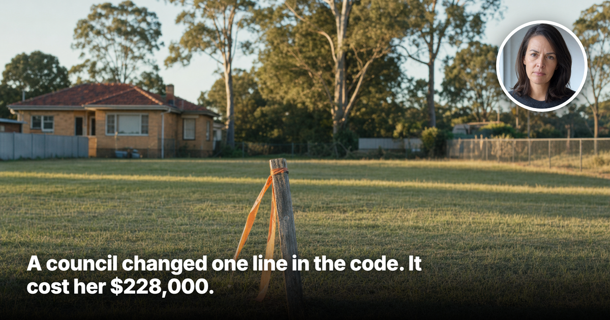 A survey peg with an orange marker ribbon standing in a large vacant suburban block at golden hour