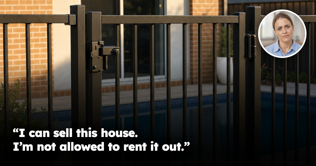 A black powder-coated aluminium pool safety fence with a self-closing gate in the foreground of an Australian suburban backyard, with a rectangular swimming pool and a single-storey brick and render house behind it in late afternoon light