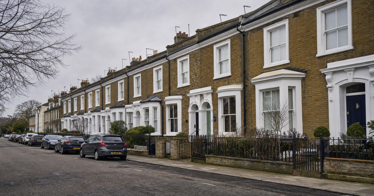 Row of London Victorian terraced houses under an overcast sky